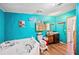 Bathroom with teal walls, a large corner bathtub, and a floating vanity at 4307 Meadow Ridge Ct, Mulberry, FL 33860