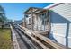 Covered porch with rocking chairs and ramp access at 4307 Meadow Ridge Ct, Mulberry, FL 33860