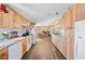 Long kitchen with light wood cabinets and granite at 4307 Meadow Ridge Ct, Mulberry, FL 33860