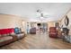 Open living room with hardwood floors, ceiling fan, and access to other rooms at 4307 Meadow Ridge Ct, Mulberry, FL 33860