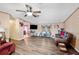Bright living room with hardwood floors, a ceiling fan and plenty of natural light at 4307 Meadow Ridge Ct, Mulberry, FL 33860