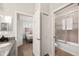 Modern bathroom with a tub and shower, granite vanity, and access to the bedroom at 4340 Reding Way, Lakeland, FL 33813