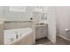 Bathroom with corner tub, vanity, and separate toilet at 4340 Reding Way, Lakeland, FL 33813