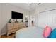 Bedroom with dresser, large TV, and access to kitchen at 4340 Reding Way, Lakeland, FL 33813