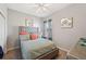 Bedroom with plush bed, coral accents, and window at 4340 Reding Way, Lakeland, FL 33813