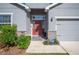 Front entrance with red door and landscaping at 4340 Reding Way, Lakeland, FL 33813