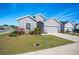 Single-story house with gray siding, red door, and attached garage at 4340 Reding Way, Lakeland, FL 33813