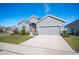 Single-story house with gray siding, red door, and attached garage at 4340 Reding Way, Lakeland, FL 33813