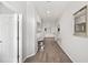 Long hallway with wood-like floors, leading to living room at 4340 Reding Way, Lakeland, FL 33813