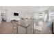 Open concept kitchen and living room with island and stainless steel appliances at 4340 Reding Way, Lakeland, FL 33813