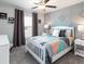 bedroom with gray walls and geometric bedding at 5451 Se 127Th Ln, Belleview, FL 34420