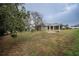 Landscaped backyard with pergola and spacious lawn at 5545 Harrells Nursery Rd, Lakeland, FL 33812