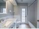 Clean bathroom with white vanity, marble countertop, and tub at 5545 Harrells Nursery Rd, Lakeland, FL 33812
