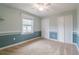 Bright bedroom with carpet flooring, ceiling fan, and double door closet at 5545 Harrells Nursery Rd, Lakeland, FL 33812
