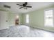 Spacious bedroom with marble floors, ceiling fan and ensuite bathroom at 5545 Harrells Nursery Rd, Lakeland, FL 33812