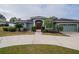 Single-story house with a green exterior, red door and landscaping at 5545 Harrells Nursery Rd, Lakeland, FL 33812