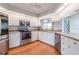 Modern kitchen with white cabinets and stainless steel appliances at 5545 Harrells Nursery Rd, Lakeland, FL 33812