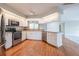 Kitchen with white cabinets, stainless steel appliances, and hardwood floors at 5545 Harrells Nursery Rd, Lakeland, FL 33812