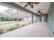 Screened porch with multiple ceiling fans and backyard access at 5545 Harrells Nursery Rd, Lakeland, FL 33812