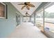 Spacious screened porch with multiple ceiling fans at 5545 Harrells Nursery Rd, Lakeland, FL 33812