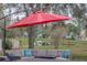 Relaxing patio furniture under an umbrella, fire pit, and pond views at 731 Lake Clark Ct, Lakeland, FL 33813