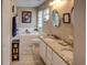 Bathroom with double vanity, granite countertop, and soaking tub at 731 Lake Clark Ct, Lakeland, FL 33813