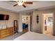 Main bedroom with wood dresser, ceiling fan, and ensuite bath at 731 Lake Clark Ct, Lakeland, FL 33813