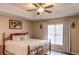 Bright bedroom with king-size bed, ceiling fan and large window at 731 Lake Clark Ct, Lakeland, FL 33813