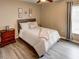 Well lit bedroom with a double bed and wood-look flooring at 731 Lake Clark Ct, Lakeland, FL 33813