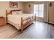 King bedroom with wood bed frame and plenty of natural light at 731 Lake Clark Ct, Lakeland, FL 33813