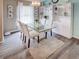 Bright dining room with glass table and built-in cabinetry at 731 Lake Clark Ct, Lakeland, FL 33813