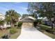 Tan house with a two-car garage and well-maintained landscaping at 731 Lake Clark Ct, Lakeland, FL 33813