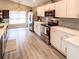 Modern kitchen with white cabinets, stainless steel appliances, and an island at 731 Lake Clark Ct, Lakeland, FL 33813