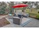 Patio furniture with fire pit and red umbrella at 731 Lake Clark Ct, Lakeland, FL 33813