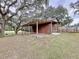 Rustic barn with covered storage area, ample space for equipment and vehicles at 7405 Havenwood Dr, Lakeland, FL 33810