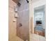 Clean bathroom with tiled shower and built-in shelves at 7405 Havenwood Dr, Lakeland, FL 33810
