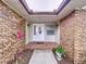 Front entry with brick facade and landscaping at 7405 Havenwood Dr, Lakeland, FL 33810