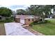 Brick home with attached garage and landscaped yard at 7405 Havenwood Dr, Lakeland, FL 33810