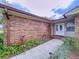 Brick house with a welcoming front porch and landscaping at 7405 Havenwood Dr, Lakeland, FL 33810