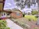 Brick house with a welcoming front porch and landscaping at 7405 Havenwood Dr, Lakeland, FL 33810