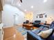 Spacious living room with hardwood floors, comfortable seating, and a large TV at 7405 Havenwood Dr, Lakeland, FL 33810