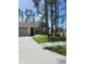 House with driveway and landscaping, located on a tree-lined street at 8052 Sugar Pine Blvd, Lakeland, FL 33810