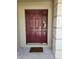 Burgundy front door with a welcome mat at 8052 Sugar Pine Blvd, Lakeland, FL 33810