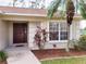 Home features a dark brown front door and lush landscaping at 8052 Sugar Pine Blvd, Lakeland, FL 33810