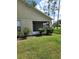 Tan house exterior with screened porch and landscaping at 8052 Sugar Pine Blvd, Lakeland, FL 33810