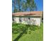 Tan house exterior with brown roof and grassy yard at 8052 Sugar Pine Blvd, Lakeland, FL 33810
