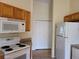 Kitchen with wood cabinets and white appliances at 8052 Sugar Pine Blvd, Lakeland, FL 33810