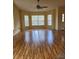 Bright living room featuring hardwood floors and a ceiling fan at 8052 Sugar Pine Blvd, Lakeland, FL 33810