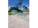 Community pool with a teal-colored equipment shed and brick pavers at 8052 Sugar Pine Blvd, Lakeland, FL 33810