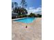 Community pool with brick patio and surrounding landscaping at 8052 Sugar Pine Blvd, Lakeland, FL 33810